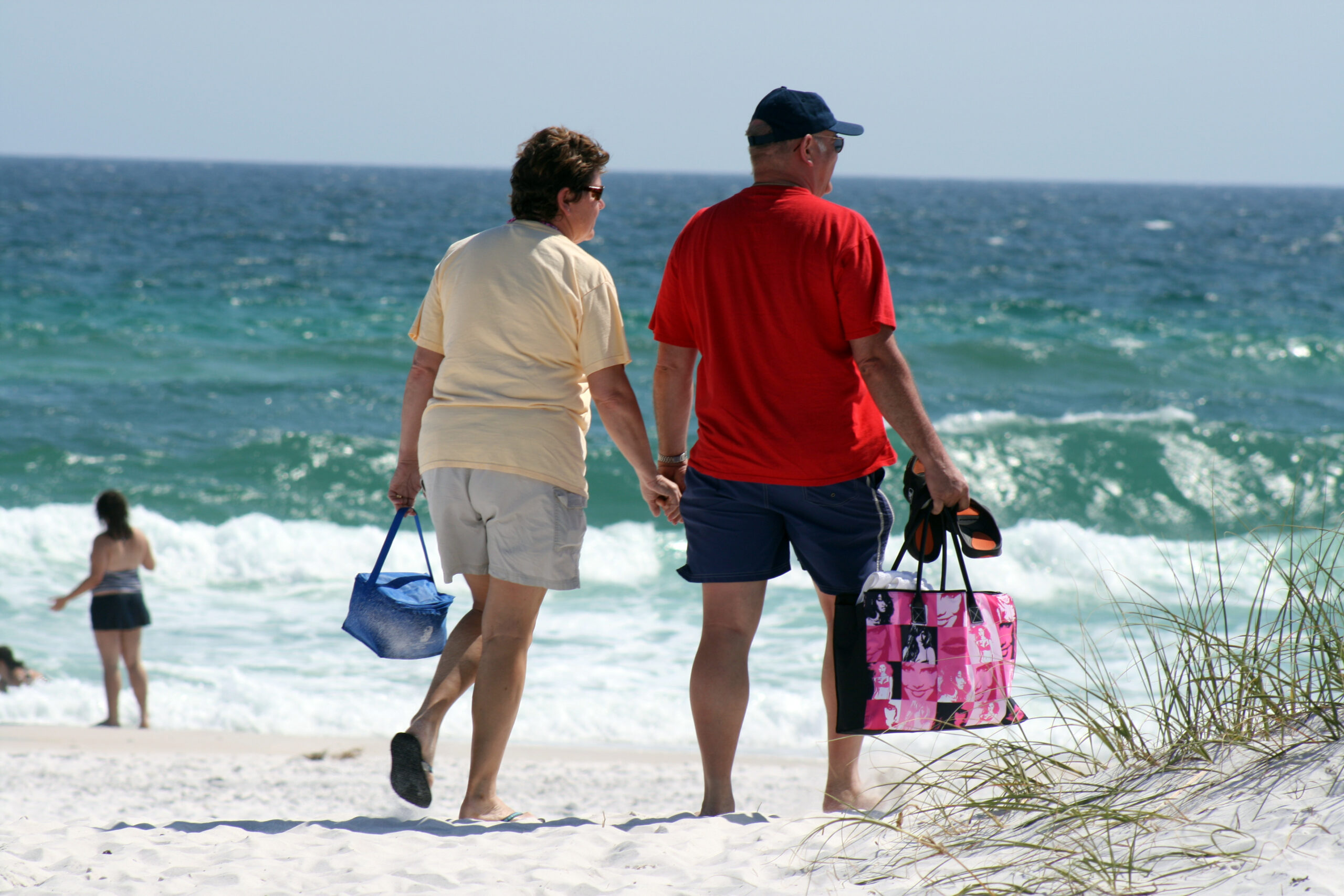 image shows retired couple walking on beach in Myrtle Beach SC on the Pearce Law Group website
